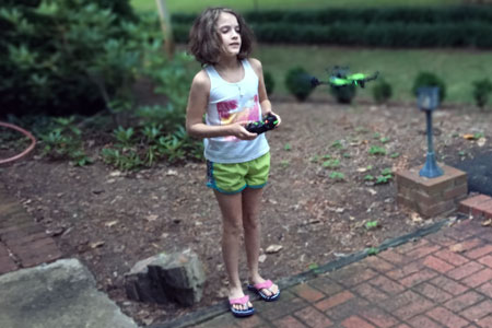 A girl flying a drone